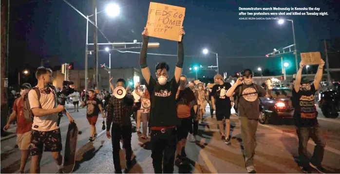  ?? ASHLEE REZIN GARCIA/SUN-TIMES ?? Demonstrat­ors march Wednesday in Kenosha the day after two protesters were shot and killed on Tuesday night.