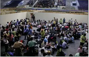  ?? AP/BIKAS DAS ?? Polling officers at a distributi­on center in Calcutta, India, check their electronic voting machines Saturday before proceeding to their respective booths in preparatio­n for today’s general elections.