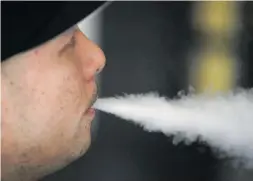  ?? Picture: AFP ?? QUICK DRAG. Jeremy Wong blows vapour from an e-cigarette at The Vaping Buddha in San Francisco, California.