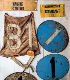  ??  ?? Andy’s collection includes historic racing numberplat­es, bibs and other mementos