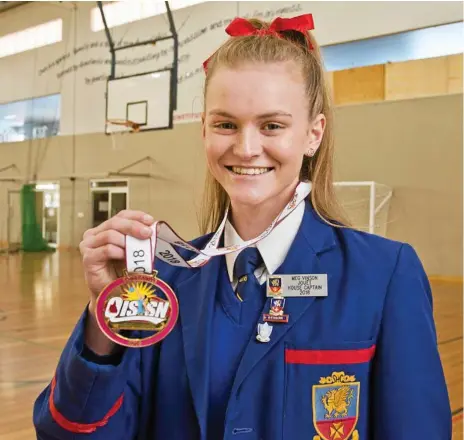  ?? Photo: Nev Madsen ?? ALL SMILES: Downlands student Meg Vinson shows off her QISSN All-Staras medal with pride.