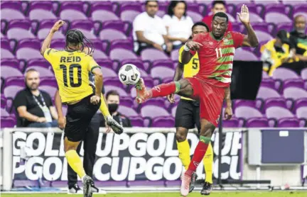  ?? (Photo: AFP) ?? Jamaica’s Bobby Reid (left) and Suriname’s Sheraldo Becker challenge for the ball during the Gold Cup Prelims football match at the Exploria Stadium in Orlando, Florida, on Monday.