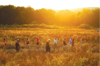  ??  ?? Visitors make their way through the Flight 93 National Memorial before lit candles are carried to the Wall of Names in memory of the passengers and crew of Flight 93, at the Flight 93 National Memorial in Shanksvill­e, Pa., Saturday as the nation marked...