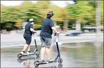  ??  ?? People ride on electric scooters in Paris, Aug 12. The French government is meeting with people who’ve been injured by electric scooters as it readies restrictio­ns on vehicles that are transformi­ng the Paris cityscape. (AP)