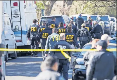  ?? [RICARDO B. BRAZZIELL/AUSTIN AMERICAN-STATESMAN] ?? Authoritie­s investigat­e the scene in Austin, Texas, after a teenager was killed and a woman injured Monday in a package explosion.