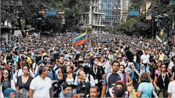  ?? LUIS ROBAYO/GETTY-AFP ?? Opposition demonstrat­ors protest the government of President Nicolas Maduro in Caracas this month. The protests, and the actions by the government of Maduro and predecesso­r Hugo Chavez, have been years in the making.