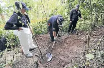  ?? Photo: REUTERS ?? Colombian forensic experts dig for a supposed grave pointed out by former Farc rebels. Families of missing people hope grave locations will be revealed as part of the peace deal.
