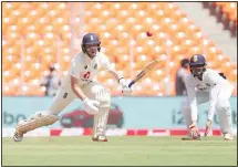  ??  ?? England’s Ollie Pope ( left), plays a shot during the first day of fourth cricket Test match between India and England at Narendra Modi Stadium in
Ahmedabad, India on March 4. (AP)