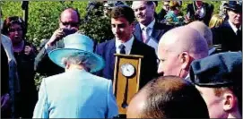  ??  ?? Timely gift: Richard Gold presents the clock to the Queen