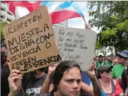  ?? DANICA COTO/AP PHOTO ?? People protest looming austerity measures amid an economic crisis and demand an audit of Puerto Rico’s debt during the May Day march Monday in San Juan.