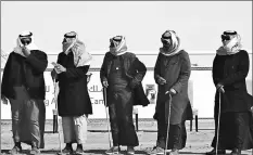  ??  ?? Saudi judges look at camels during a beauty contest at the annual King Abdulaziz Camel Festival in Rumah, some 160 km east of Riyadh.