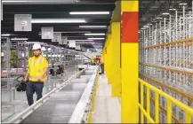  ?? File photo ?? State and local officials tour the inside of the new North Haven Amazon site in June.