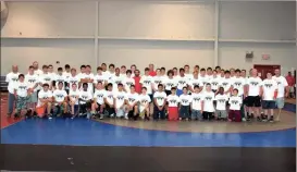  ?? Photos by LARRY GREESON / For the Calhoun Times ?? ( Campers and instructor­s pose for a group photo on the final day of Stew Train Camp on Thursday. ( Camper Jayden Moore (top) wrestles on Wednesday at camp.