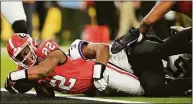  ?? Ashley Landis / Associated Press ?? Georgia running back Branson Robinson (22) falls into the end zone against TCU safety Mark Perry during the second half of the national championsh­ip NCAA College Football Playoff game Monday in Inglewood, Calif.