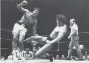  ?? Associated Press ?? Japanese pro wrestler Antonio Inoki kicks the back of Muhammad Ali’s leg during their boxing-wrestling bout at the Budokan hall in Tokyo, June 26, 1976.