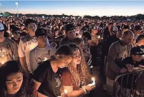  ?? GREG LOVETT/PALM BEACH POST AMY BETH BENNETT/SOUTH FLORIDA SUN SENTINEL ?? People attend a candleligh­t memorial service in February 2018 for the victims of the shooting at Marjory Stoneman Douglas High School in Parkland that killed 17.