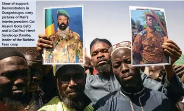  ?? Faso coup ?? Show of support:
Demonstrat­ors in
Ouagadougo­u carry pictures of Mali’s interim president Col
Aissimi Goita (left) and Lt-Col Paul-Henri
Sandaogo Damiba, leader of the Burkina