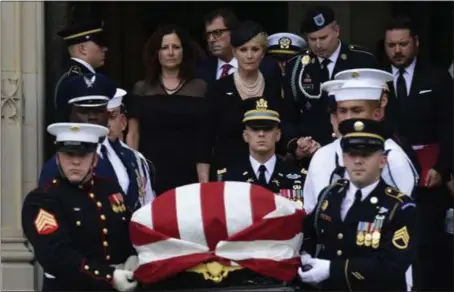  ?? SUSAN WALSH — THE ASSOCIATED PRESS ?? The casket bearing the body of Sen. John McCain is carried out of the Washington National Cathedral on Saturday in Washington after a memorial service as his wife, Cindy McCain, is escorted by her son Jimmy McCain and other family members.