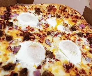  ?? Chuck Blount / Staff ?? The Big Over Easy pizza at Broken Stone Pizza Co. incorporat­es four over-easy eggs.