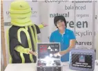  ??  ?? Energy-saving mascot, Switch and Priscilla Moodley from eThekwini’s Energy Office with the lighting display that demonstrat­es the difference in energy consumptio­n of different lighting options.