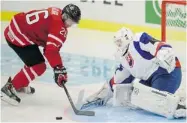  ?? FRANK GUNN/ THE CANADIAN PRESS ?? Canada’s Curtis Lazar moves in on Slovakia’s goalie Samuel Baros at the World Juniors in Malmo, Sweden, on Monday.