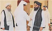  ?? ?? Mutlaq al-qahtani, left, Qatar’s counter-terrorism envoy, shakes hands with Mullah Abdul Ghani Baradar, a co-founder of the Taliban, before talks in Doha yesterday