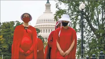  ?? J. Scott Applewhite Associated Press ?? to Supreme Court nominee Amy Coney Barrett protest in Washington on Sunday.