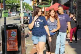  ?? MICHILEA PATTERSON — DIGITAL FIRST MEDIA ?? People walk along E. High St. in Pottstown during the opening day of the outdoor farmers market on Thursday. The seasonal, weekly market will be every Thursday from 5 to 7:30 p.m.