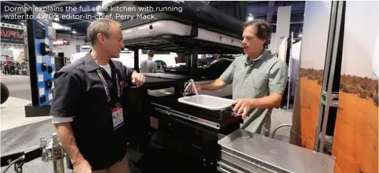  ??  ?? Dorman explains the full slide kitchen with running water to 4WD's editor-in-chief, Perry Mack.