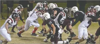  ??  ?? Blackhawk Zaine Holley, No. 2, Jonathon Small, No. 63, and Cody Foltz, No. 25, on defense against Huntsville Friday night.