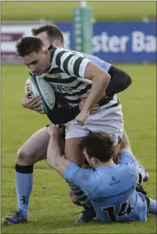  ??  ?? Matt O’Brien of Greystones is taken down by Galwegians duo Justin Coen and Daniel Carr.