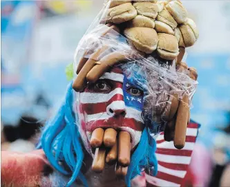  ?? EDUARDO MUNOZ ALVAREZ GETTY IMAGES ?? A man in costume attends Nathan’s Hot Dog Eating Contest, held at Coney Island every July 4, the day Americans celebrate their country’s independen­ce — and their own importance.