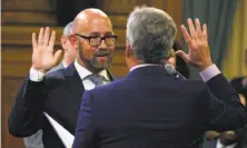  ?? Paul Chinn / The Chronicle ?? Rafael Mandelman is sworn in as District Eight’s supervisor by Dennis Herrera, San Francisco’s city attorney.