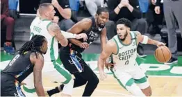  ?? OMARRAWLIN­GS/GETTY ?? The Celtics’Jayson Tatum, who scored 20 points Friday, drives to the basket during the first quarter against the Nets in Boston.