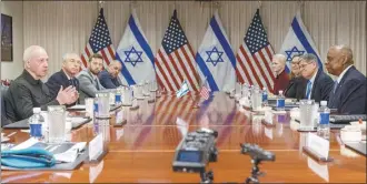  ?? AP photo ?? Israeli Defense Minister Yoav Gallant (at far left), speaks while meeting with Defense Secretary Lloyd Austin (across table at far right), at the Pentagon on Tuesday, in Washington.