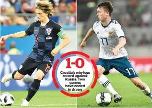  ?? AFP ?? Croatia’s midfielder Luka Modric (left) and Russia’s midfielder Aleksandr Golovin. —