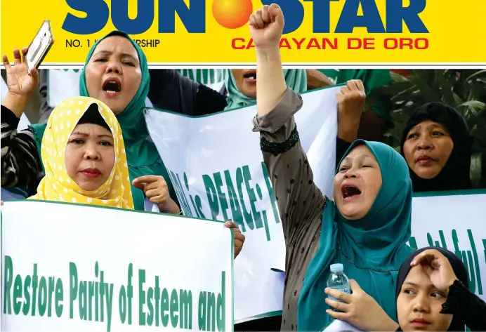  ?? (AP) ?? Filipino Muslims and Christians shout slogans during an inter-faith rally at the EDSA Shrine to urge lawmakers to restore certain provisions in the proposed Bangsamoro Basic Law (BBL) which they fear were deleted by either or both houses of Congress...