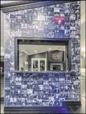  ??  ?? A bar off the front door is faced with a custom vinyl wall wrap featuring black and white photos of virtually every entertaine­r to ever play Las Vegas.