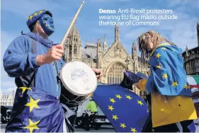  ??  ?? Demo Anti-Brexit protesters wearing EU flag masks outside theHouse of Commons