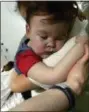  ?? ALFIES ARMY OFFICIAL VIA AP ?? In this April 23, 2018 handout photo provided by Alfies Army Official, brain-damaged toddler Alfie Evans cuddles his mother Kate James at Alder Hey Hospital, Liverpool, England. Kate James and Tom Evans, the parents, said on Facebook that 23-monthold...