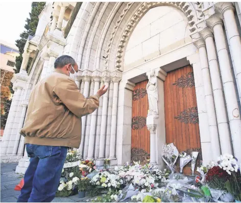  ?? FOTO: BOTELLA/DPA ?? Obwohl seit Freitag strenge Lockdown-regeln gelten, legten viele Menschen Blumen vor der Basilika Notre-dame in Nizza nieder.