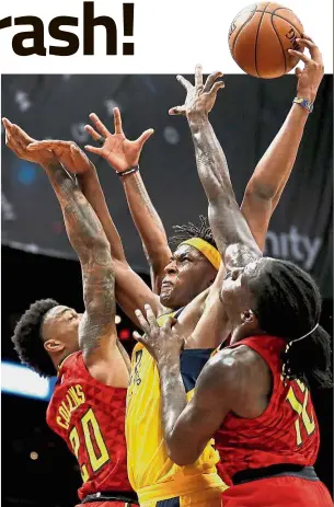  ??  ?? Hands up: Indiana Pacers’ Myles Turner (centre) puts up a shot against Atlanta Hawks’ John Collins (left) and Taurean Prince during their NBA game on Wednesday.