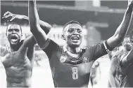  ?? AP ?? Cameroon’s Benjamin Moukandjo (centre) celebrates with his teammates their 2-0 victory in the African Cup of Nations semi-final against Ghana at the Stade de Renovation, in Francevill­e, Gabon yesterday.