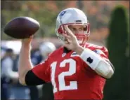  ?? STEVE SENNE - THE ASSOCIATED PRESS ?? New England Patriots quarterbac­k Tom Brady winds up for a pass during practice Wednesday.