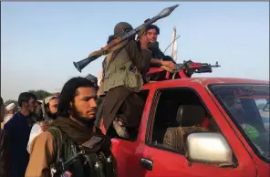  ?? AP/RAHMAT GUL ?? Taliban fighters ride Saturday through the Surkhroad district of Afghanista­n’s Nangarhar province, in the region where the suicide bombing occurred.