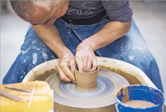  ?? Photog raphs by Marcus Yam
Los Angeles Times ?? MORIHIRO ONODERA went from kitchen to kiln, selling his sushi restaurant to focus on making pottery. Here, he works at Xiem Clay Center in Pasadena.