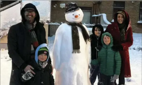  ??  ?? Chris McCullough, Rory McCullough, Rohan Porter-Fogarty, Elliott Porter-Fogarty and Louisa Porter with their snowman in Bray.