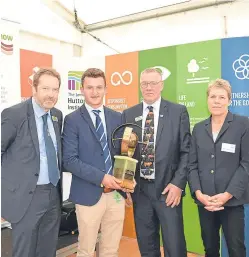 ??  ?? Alistair Brunton received his award from NFU Scotland president Andrew McCornick. Looking on are James Hutton Institute chief executive Professor Colin Campbell and Soil Associatio­n chief executive Helen Browning.
