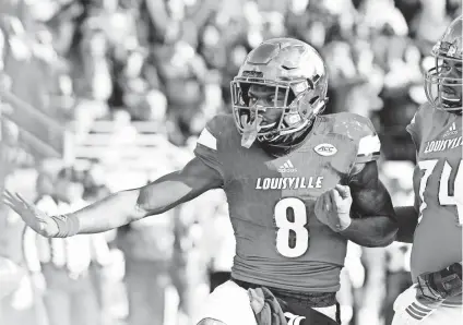  ?? JAMIE RHODES/USA TODAY SPORTS ?? Louisville quarterbac­k Lamar Jackson strikes a pose after scoring a touchdown against Kentucky on Nov. 26. Jackson, who was named a finalist for the Heisman Trophy on Monday, ended the regular season with 3,390 passing yards, 1,538 rushing yards and 51...