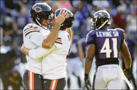  ?? ROB CARR / GETTY IMAGES ?? Chicago’s Connor Barth and Pat O’Donnell celebrate after Barth kicked a game-winning 40-yard field goal in overtime against the Ravens.